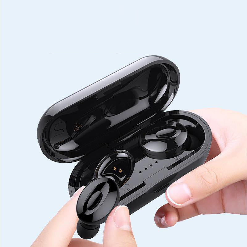 Wireless sports headphones for fitness in a charging case held by a hand, showcasing modern design and portability.