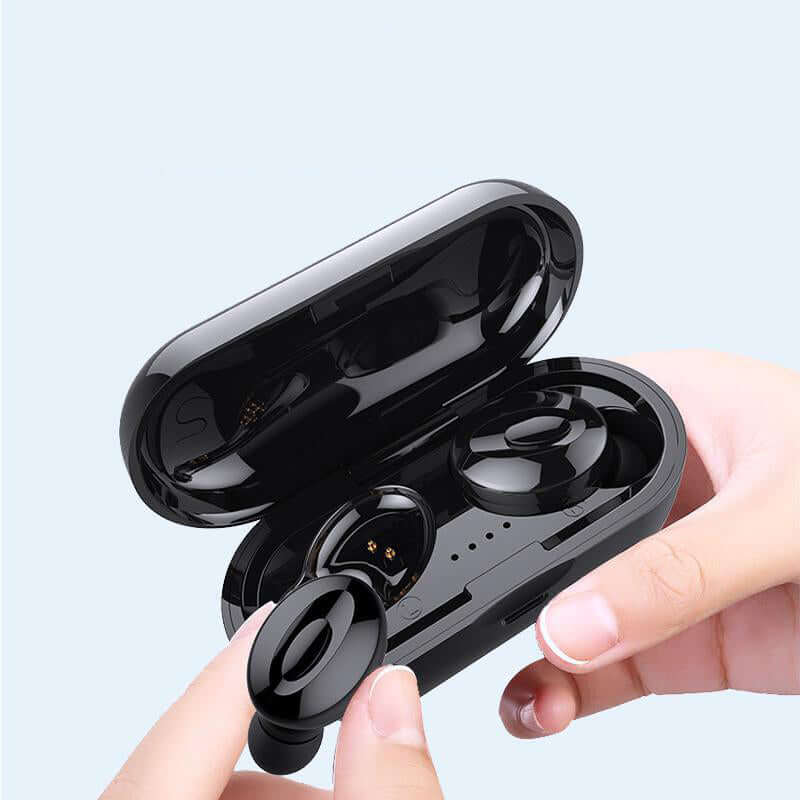 Wireless sports headphones for fitness in a charging case held by a hand, showcasing modern design and portability.