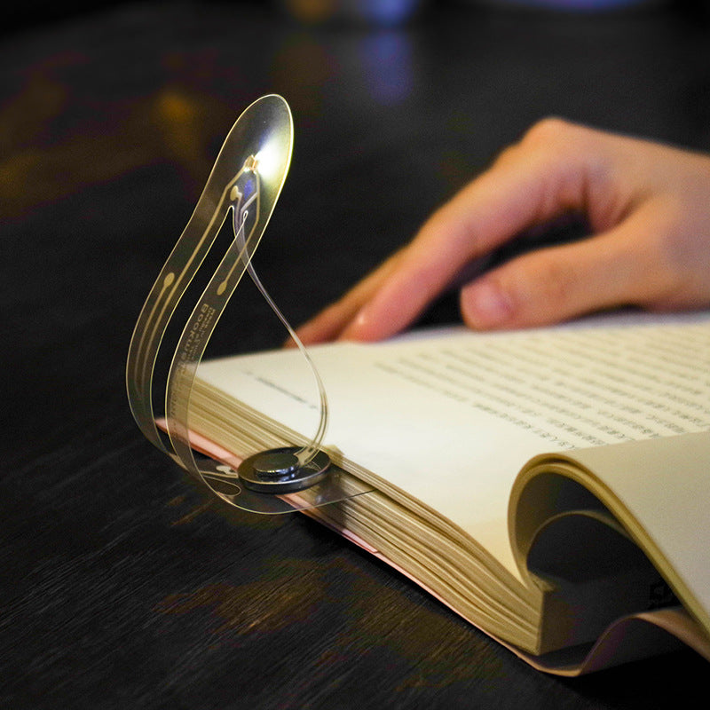 High-tech reading lamp illuminating a book page with a sleek and modern design for optimal visibility.